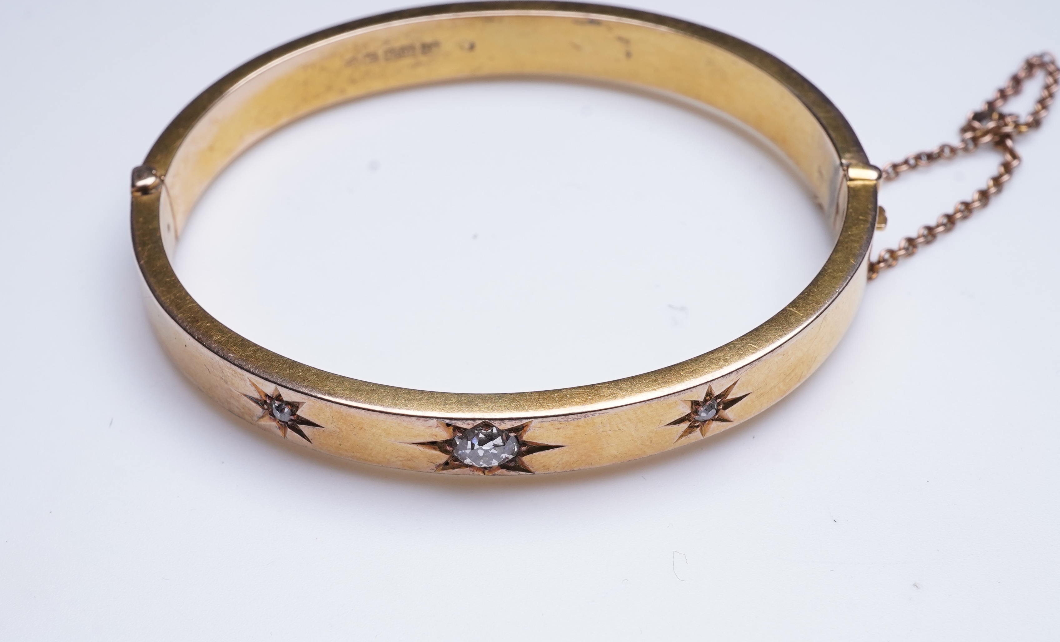 An Edwardian 15ct gold and diamond bangle, circa 1904